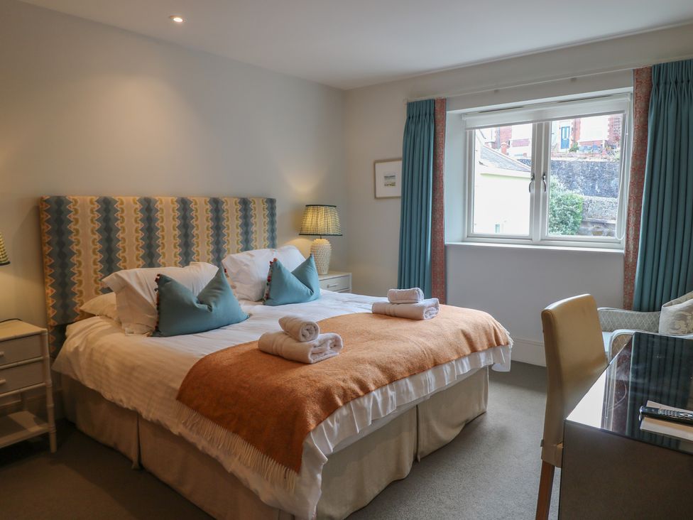 A bedroom with a double bed and window at 22 Dart Marina in Dartmouth