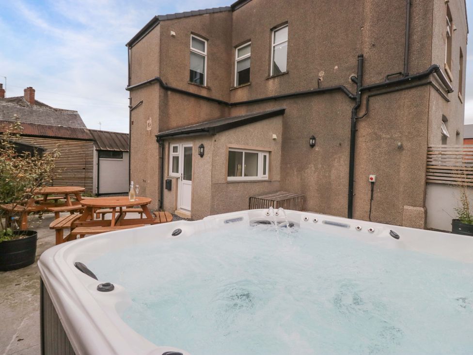 An outdoor area with a hot tub and seating at Lund House in Ulverston