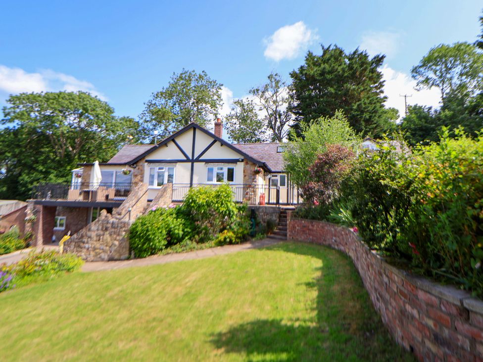 A house with a garden and balcony at The Old Barn in Pentre Celyn
