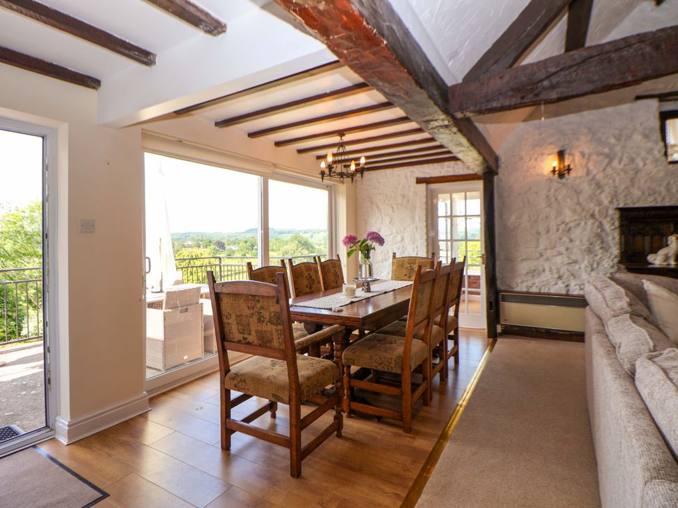 A dining room with a table and chairs at The Old Barn in Pentre Celyn