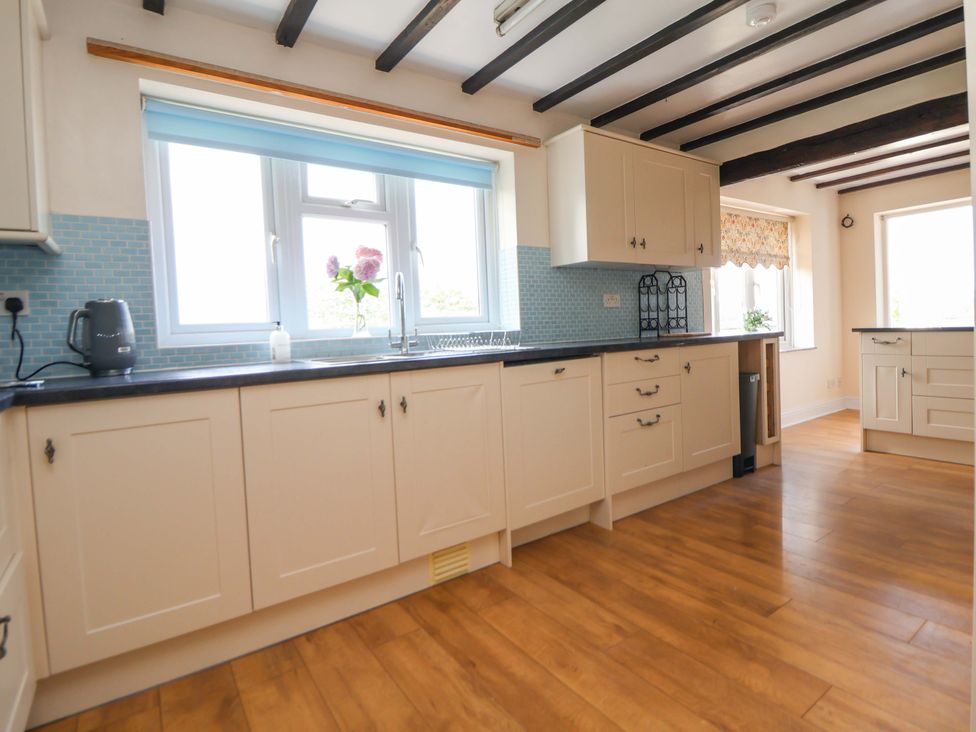 A kitchen with cabinets and a sink at The Old Barn in Pentre Celyn