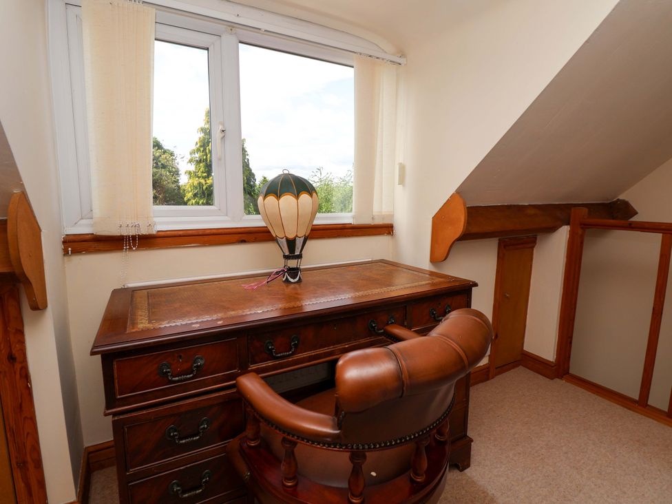 An office with a desk and a balloon ornament at The Old Barn in Pentre Celyn