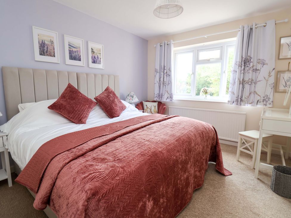 A bedroom with a bed and window at The Old Barn in Pentre Celyn