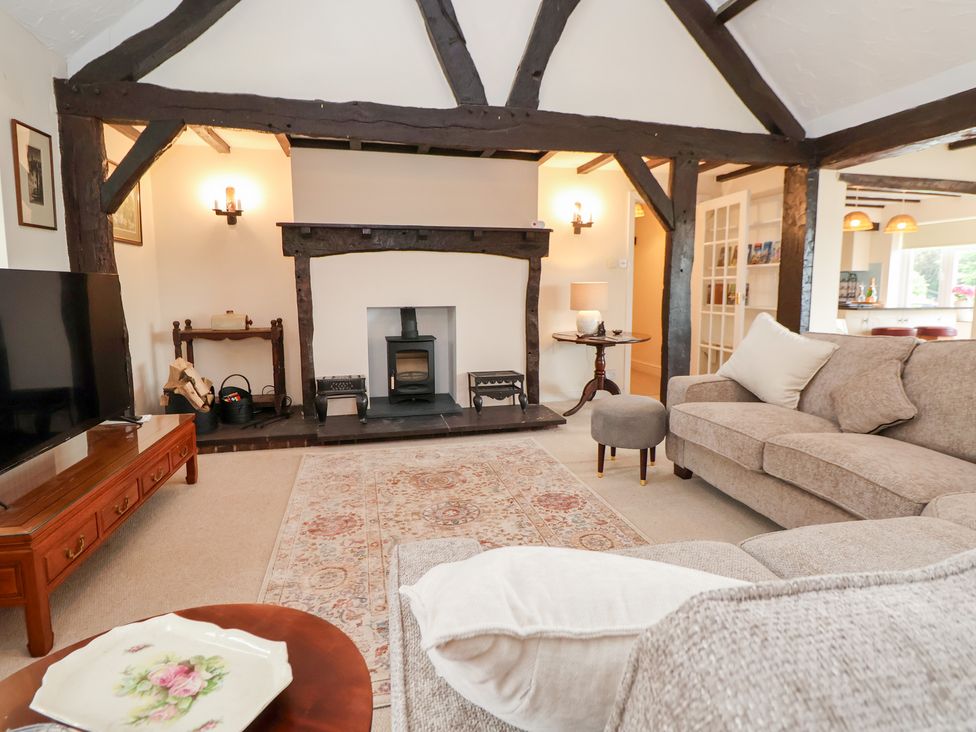 A living room with a sofa and television at The Old Barn in Pentre Celyn
