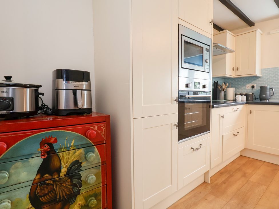 A kitchen with appliances and cabinets at The Old Barn in Pentre Celyn