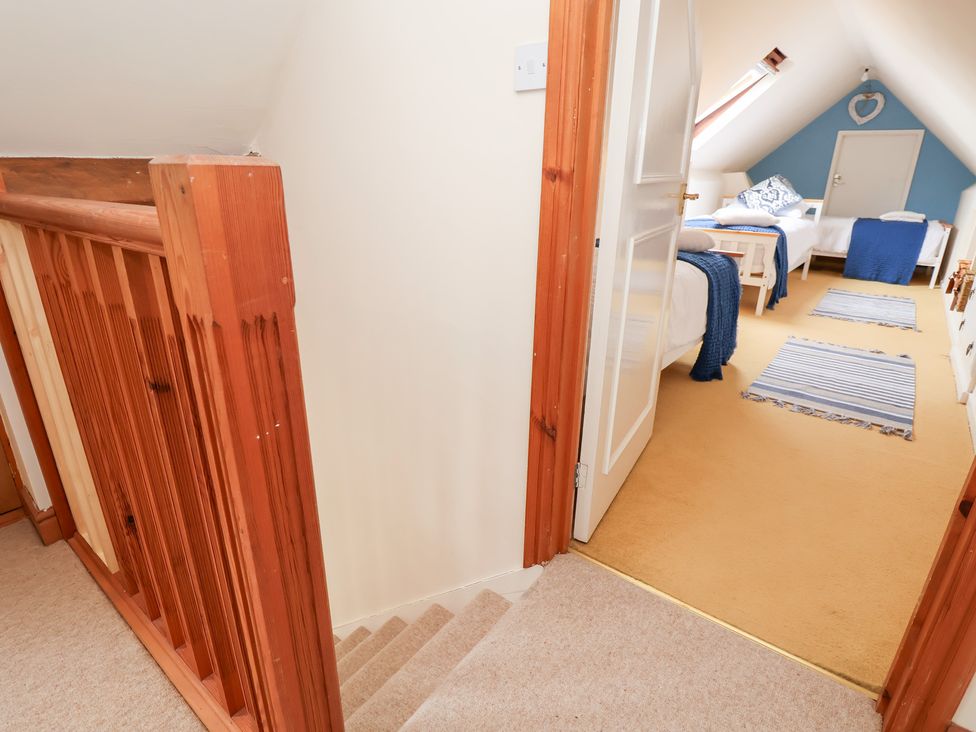 A hallway with a staircase leading up to a bedroom at The Old Barn in Pentre Celyn