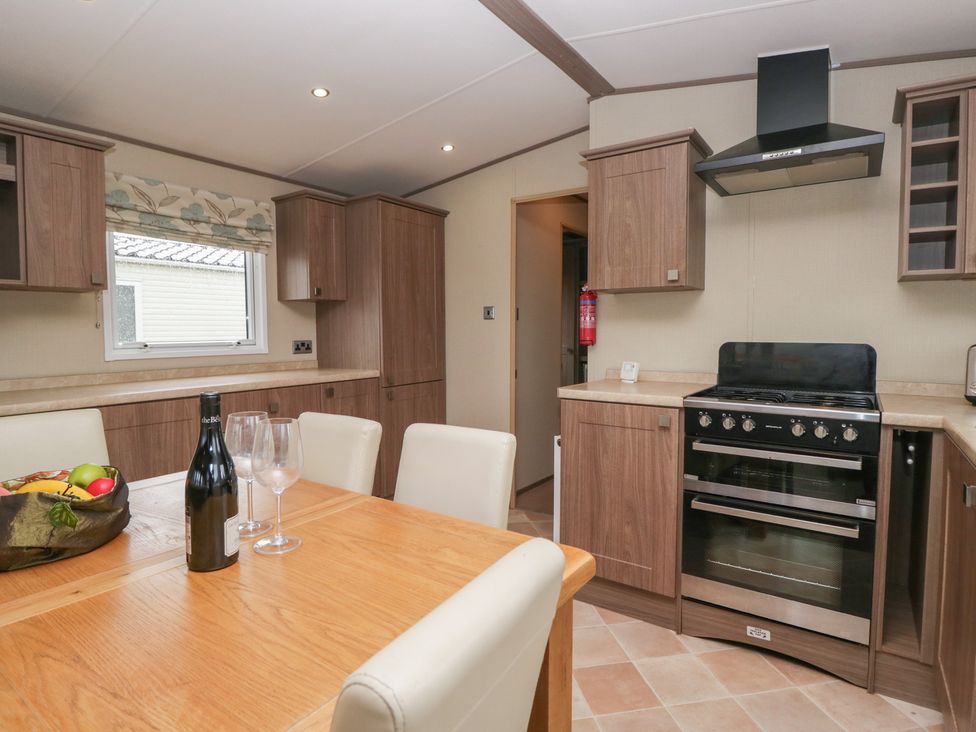 A kitchen with a table and chairs at Aspen in Denny