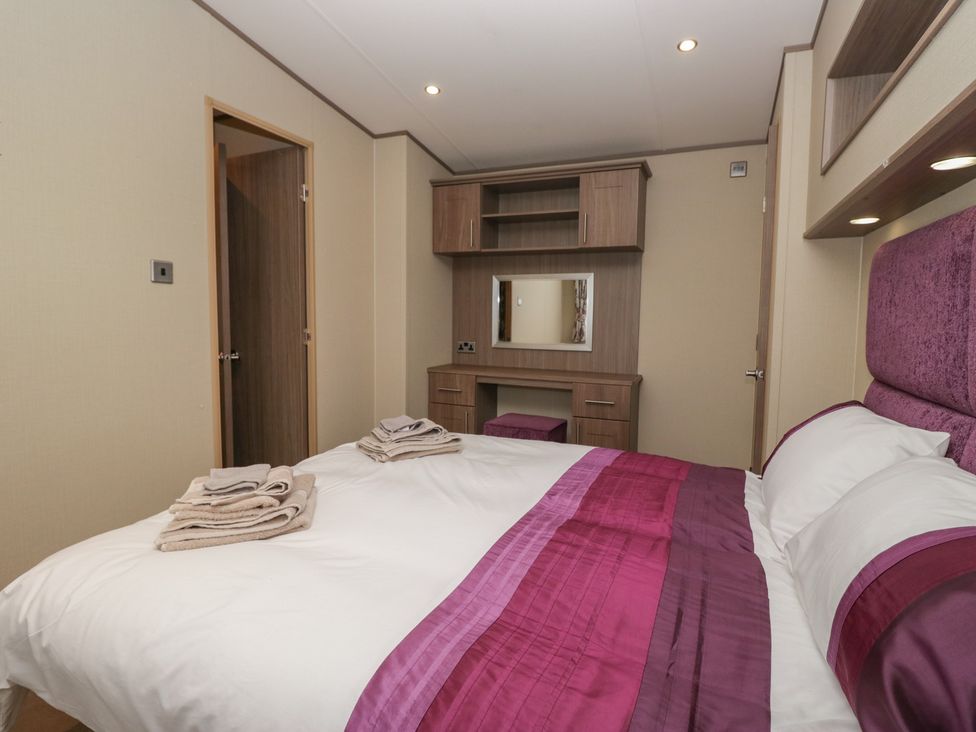 A bedroom with a bed and dresser at Aspen in Denny