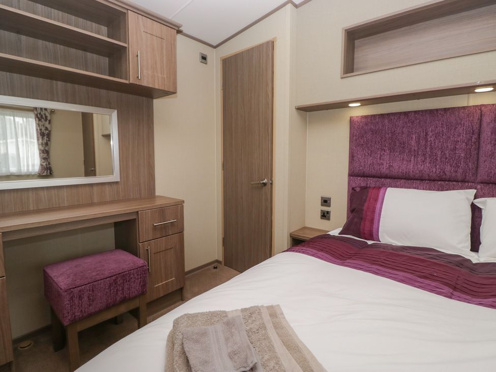 A bedroom with a bed and a desk at Aspen in Denny