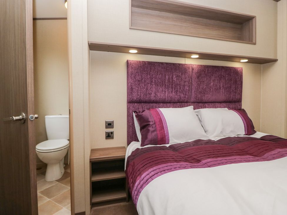 A bedroom with a bed and a toilet at Aspen in Denny