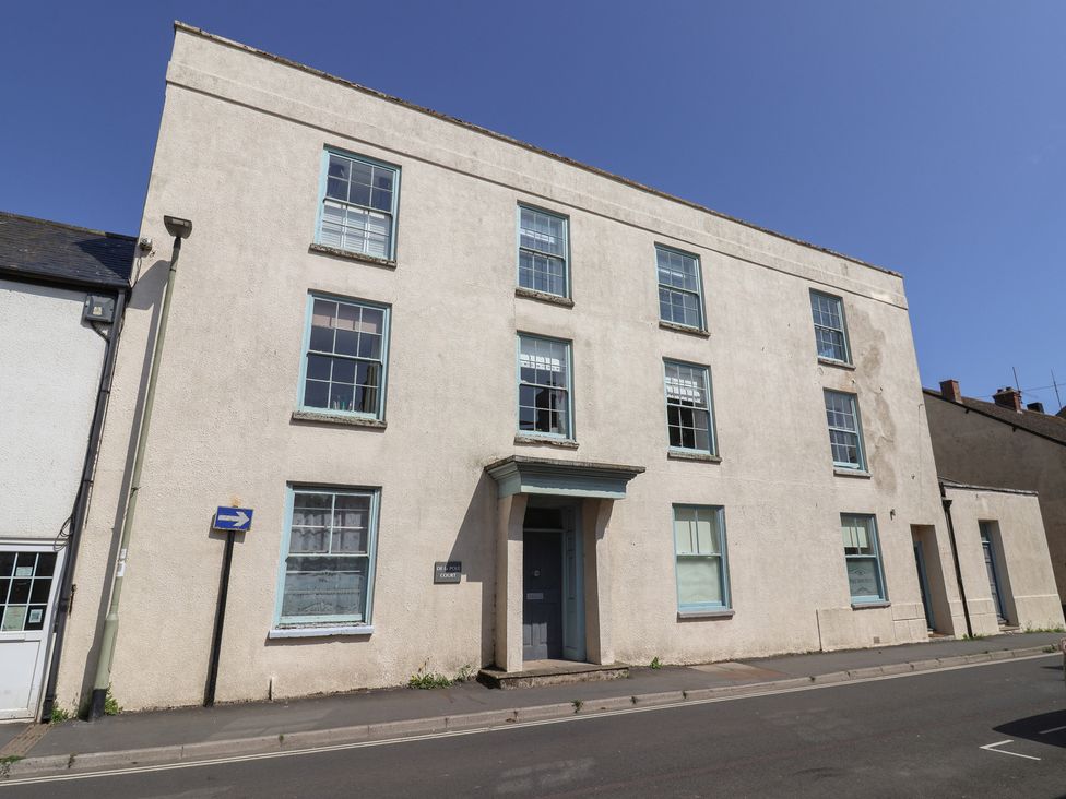 A building with multiple windows and a door at Cliff View in Seaton