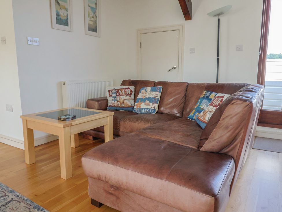 A living room with a sofa and coffee table at Cliff View in Seaton