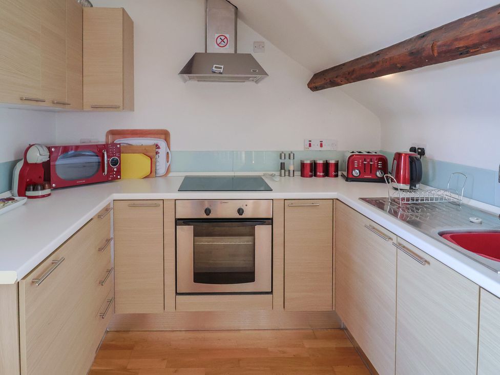 A kitchen with cabinets and appliances at Cliff View in Seaton