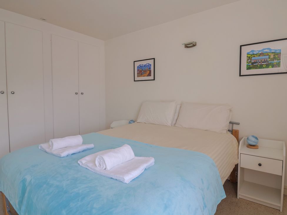A bedroom with a bed and bedside table at Cliff View in Seaton
