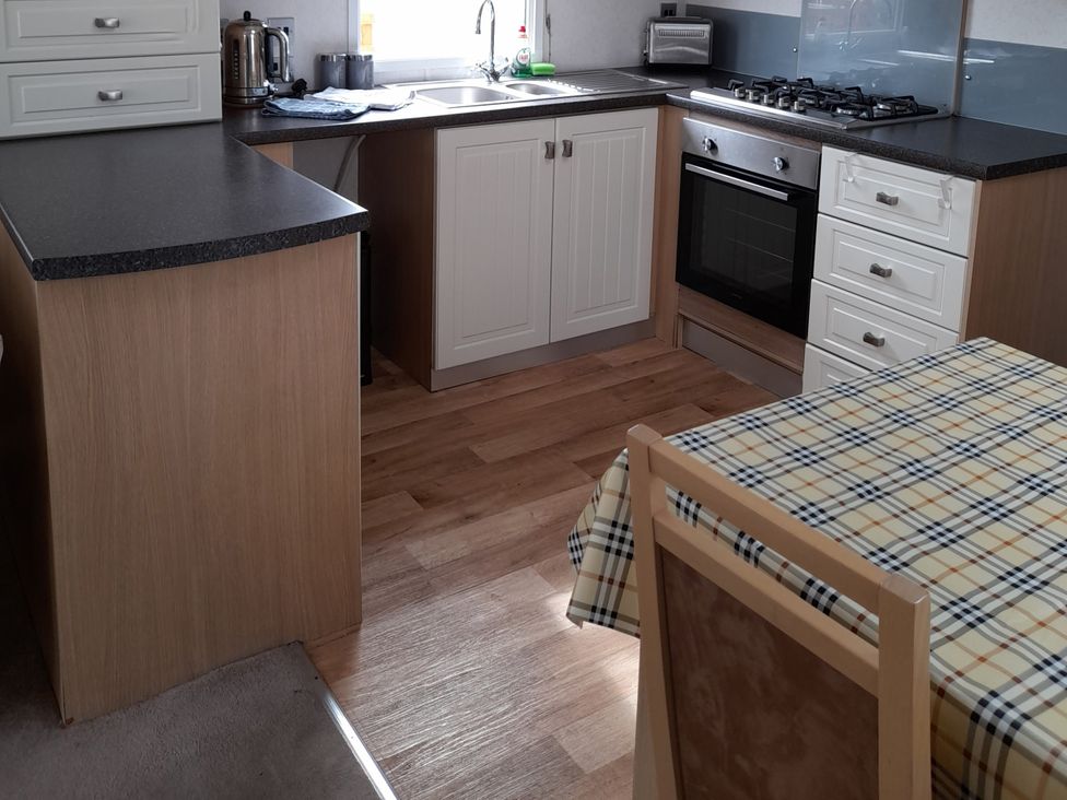 A kitchen with a sink and oven at Oak in Denny