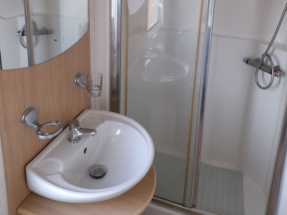 A bathroom with a sink and shower at Oak in Denny