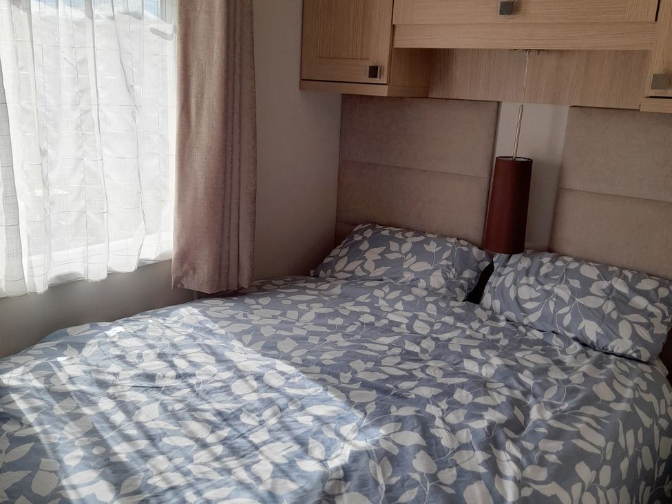 A bedroom with a bed and curtains at Yew in Denny