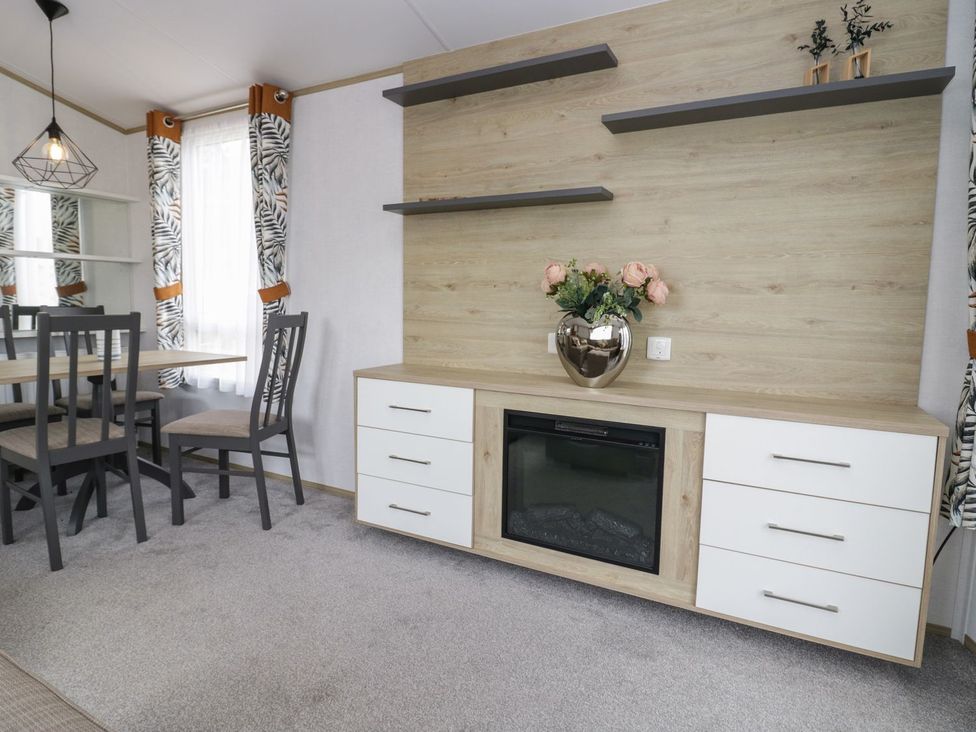 A dining room with a table and chairs at Ash in Denny