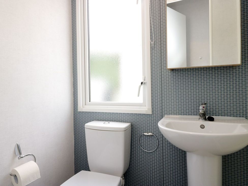 A bathroom with a sink and toilet at Ash in Denny