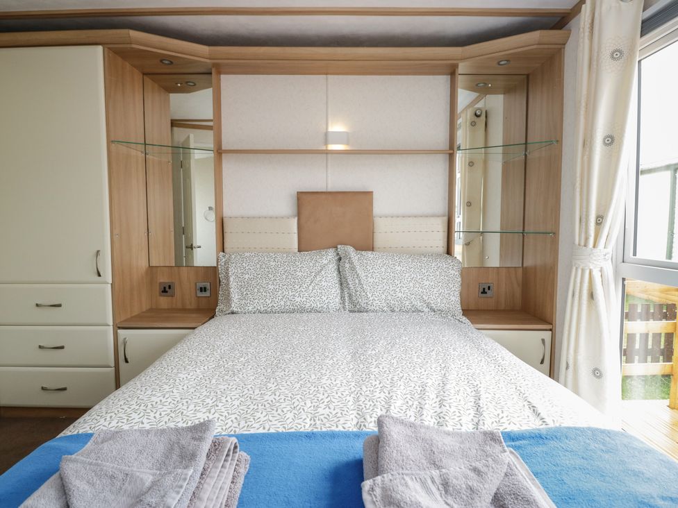 A bedroom with a bed and a wardrobe at Willow in Denny
