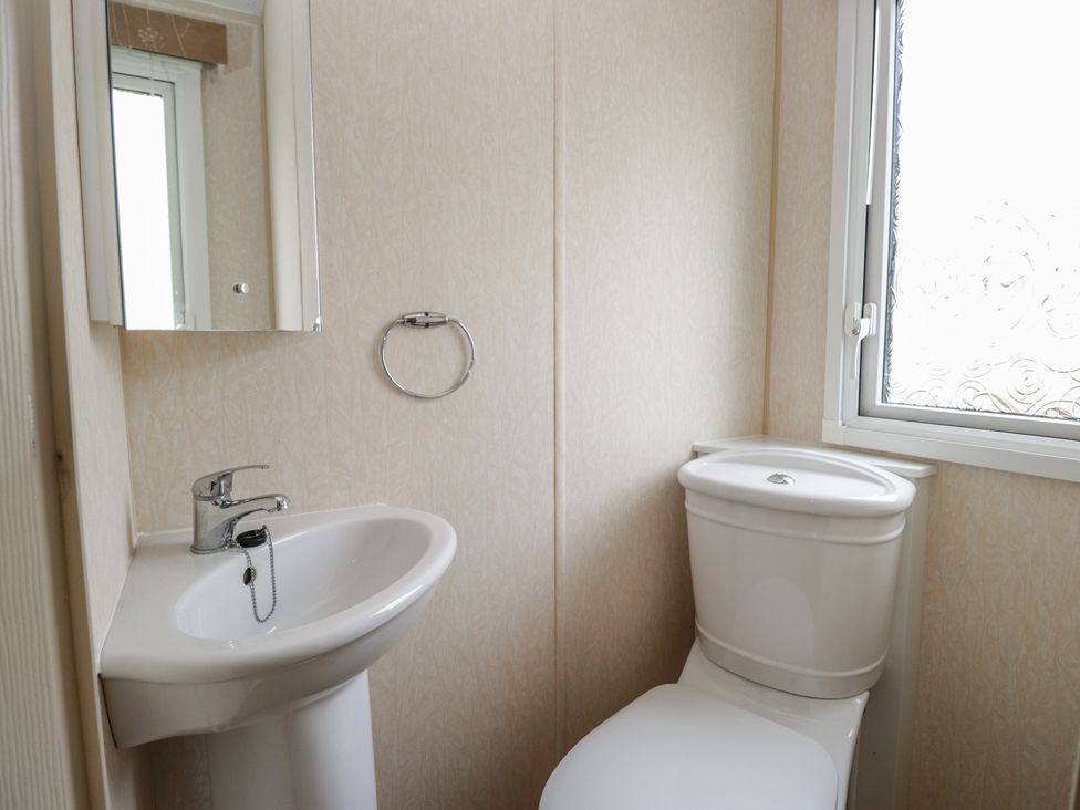 A bathroom with a sink and toilet at Birch in Denny