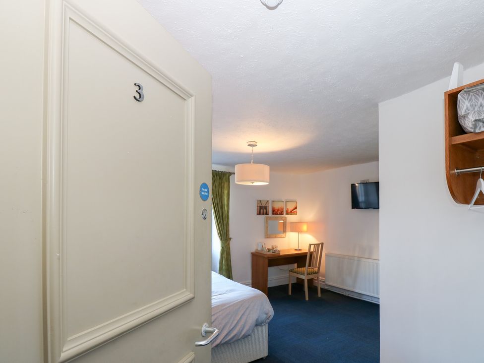 A bedroom with a bed and desk at Bedroom 3 Bishop Auckland