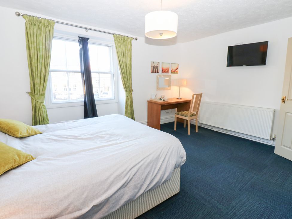 A bedroom with a bed and desk at Bedroom 3 in Bishop Auckland