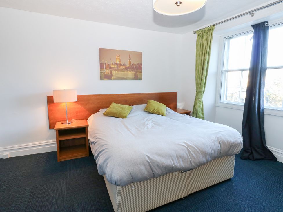 A bedroom with a bed and lamp at Bedroom 3 in Bishop Auckland
