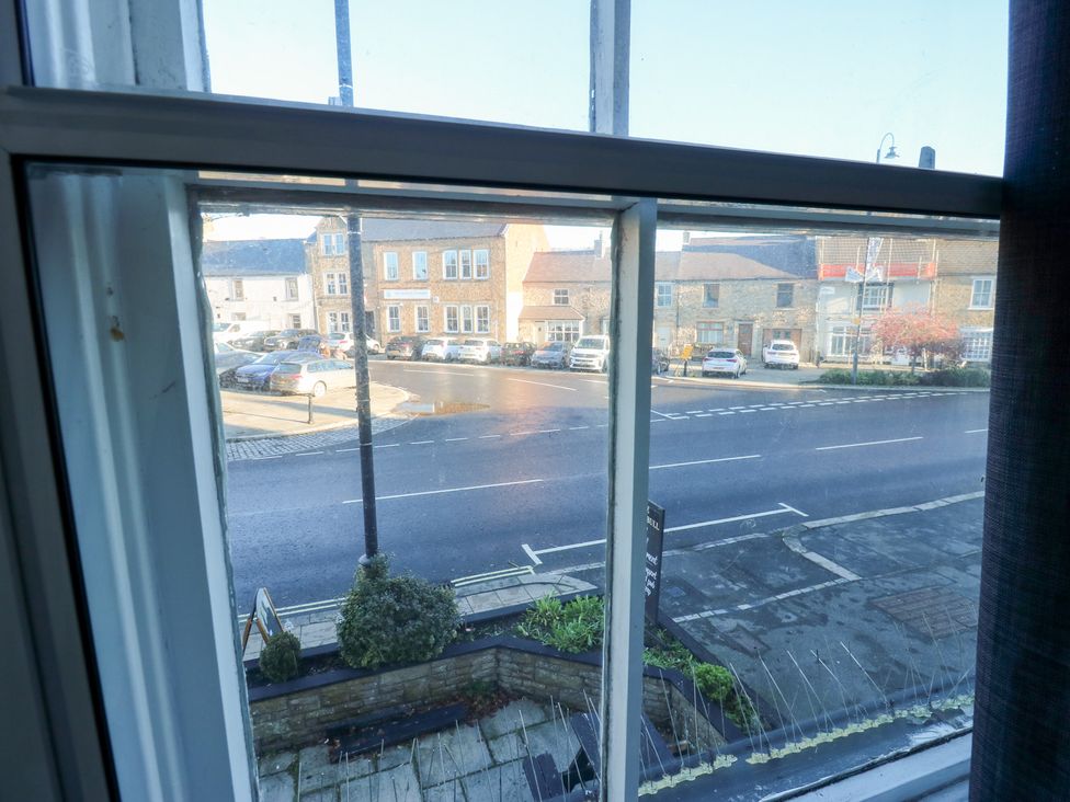 A view of the street with cars from a window at Bedroom 3 in Bishop Auckland