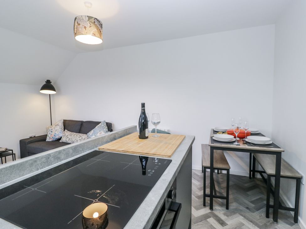 A kitchen with a dining table and seating at Claife Flights in Bowness-On-Windermere
