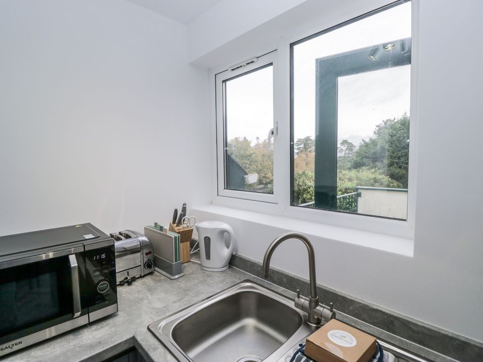 A kitchen with a sink and appliances at Claife Flights in Bowness-On-Windermere