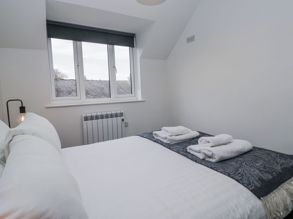A bedroom with a bed and towels on top at Claife Flights Bowness-On-Windermere