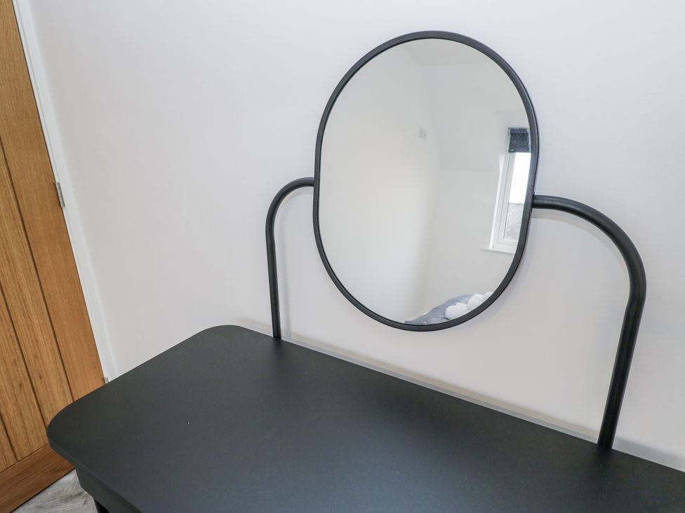 A dressing table with a mirror in a bedroom at Claife Flights Bowness-On-Windermere