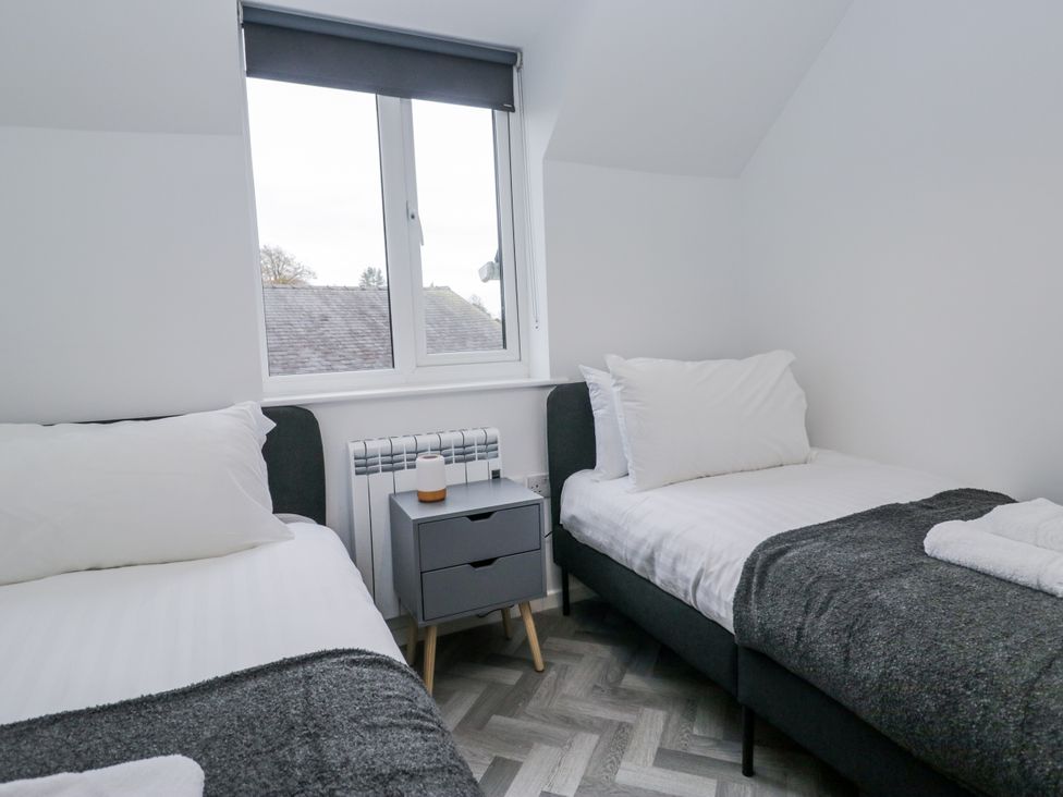 A bedroom with two beds and a window at Claife Flights in Bowness-On-Windermere