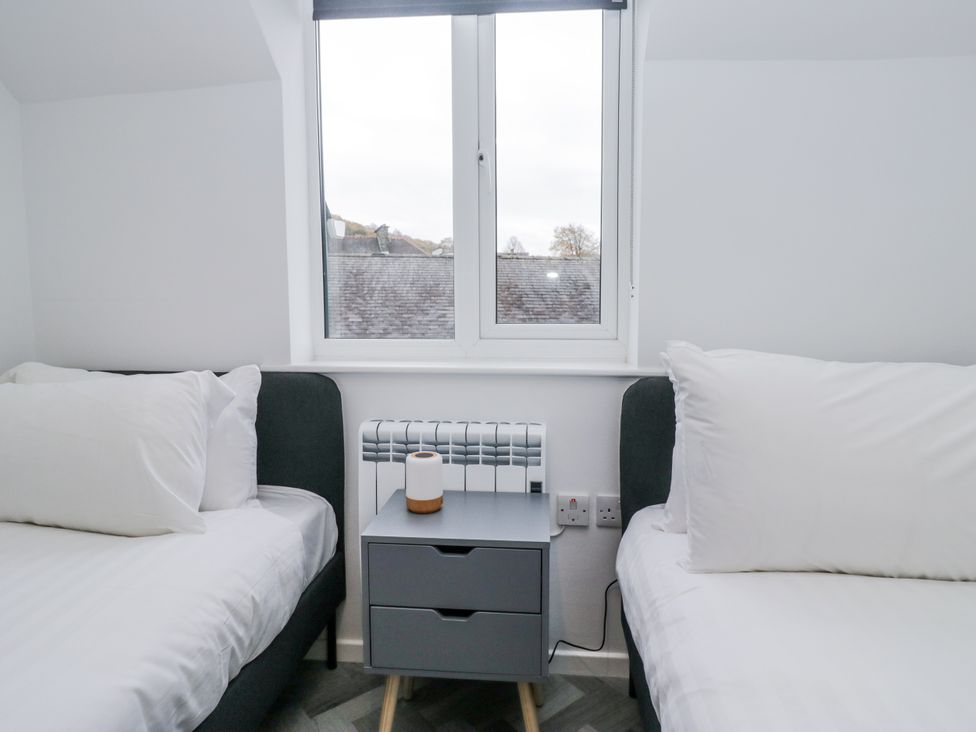 A bedroom with two beds and a window at Claife Flights Bowness-On-Windermere