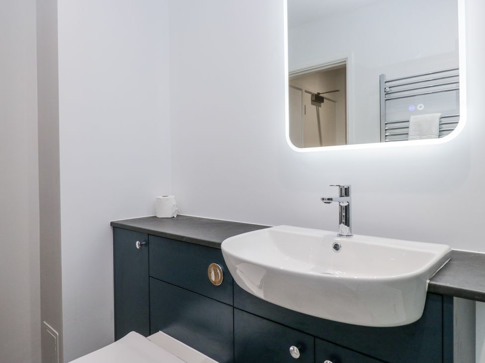 A bathroom with a sink and mirror at Claife Flights in Bowness-On-Windermere