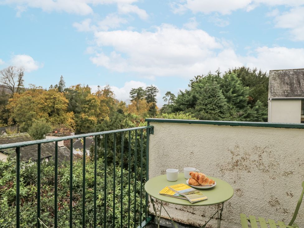 A table with croissants and mugs on a balcony at Claife Flights in Bowness-On-Windermere