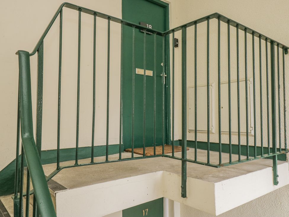 A staircase landing with a door numbered 18 at Claife Flights in Bowness-On-Windermere