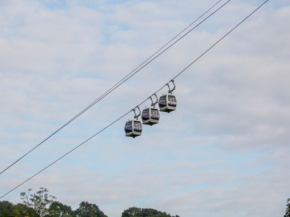 Cable cars on a cable system under a cloudy sky