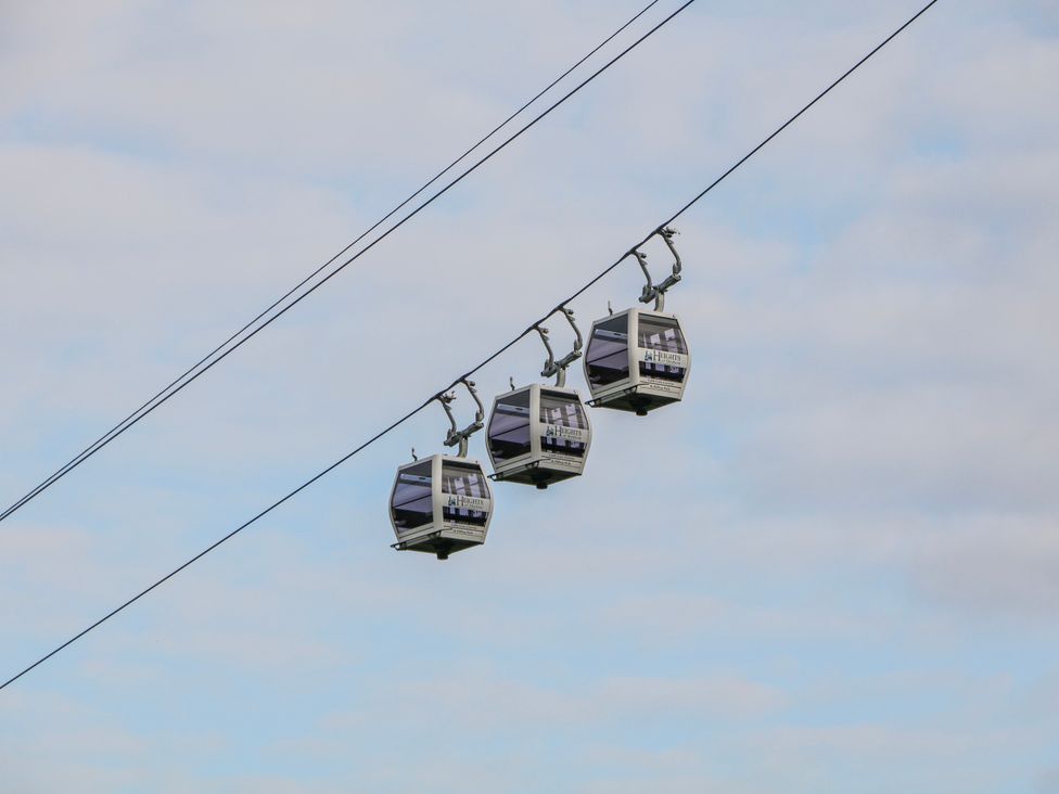 Gondolas on a cable against a cloudy sky at High Tor (84) Studio Matlock