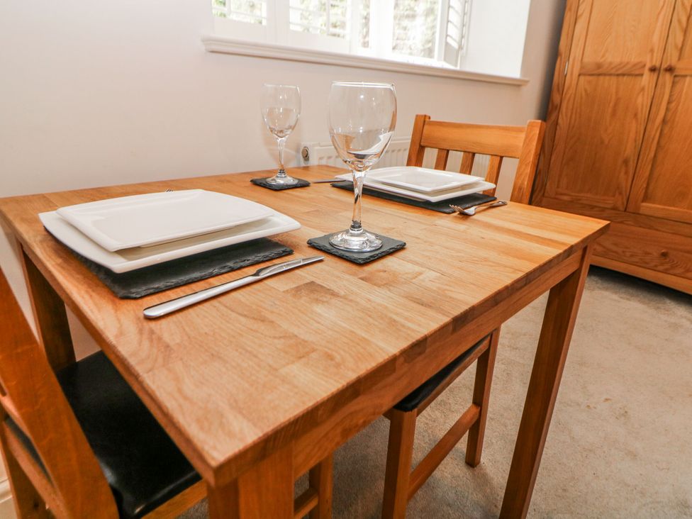 A dining room setup with a table and chairs at Riber in Matlock Bath