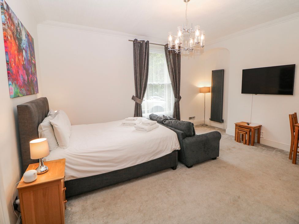 A bedroom with a bed and a sofa at Arkwright in Matlock