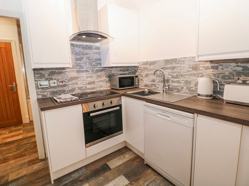 A kitchen with an oven, dishwasher, and microwave at Arkwright in Matlock