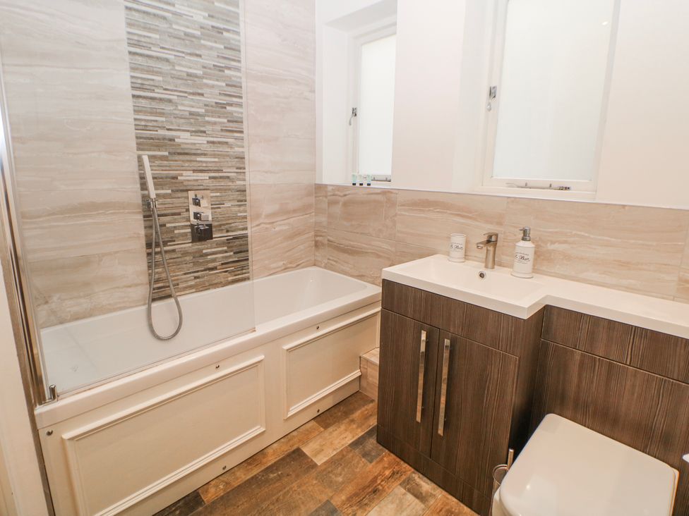 A bathroom with a bathtub and shower at Arkwright in Matlock