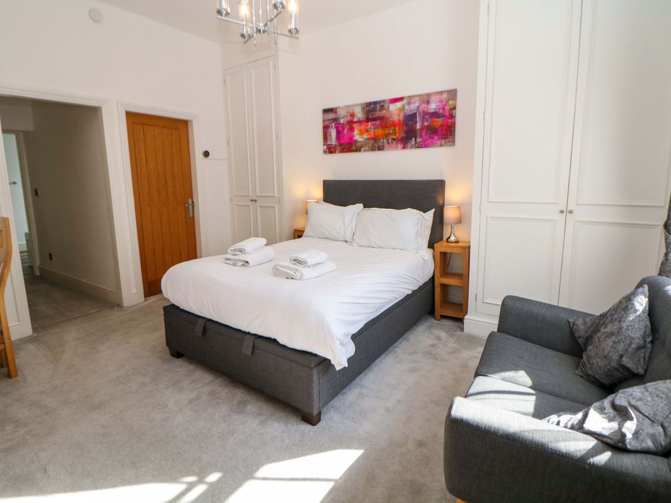 A bedroom with a bed and sofa at Lumsdale Matlock Bath
