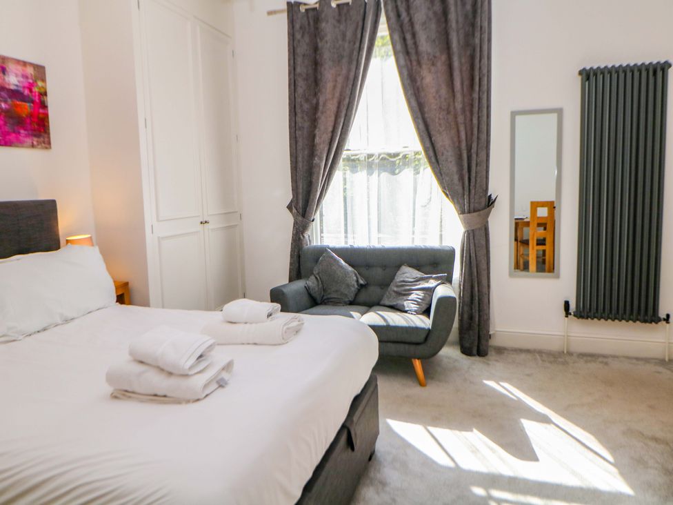 A bedroom with a bed and couch at Lumsdale in Matlock Bath