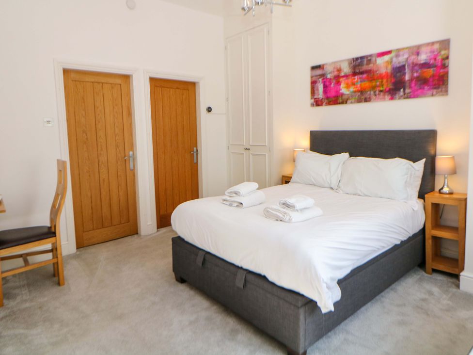 A bedroom with a bed and two doors at Lumsdale Matlock Bath