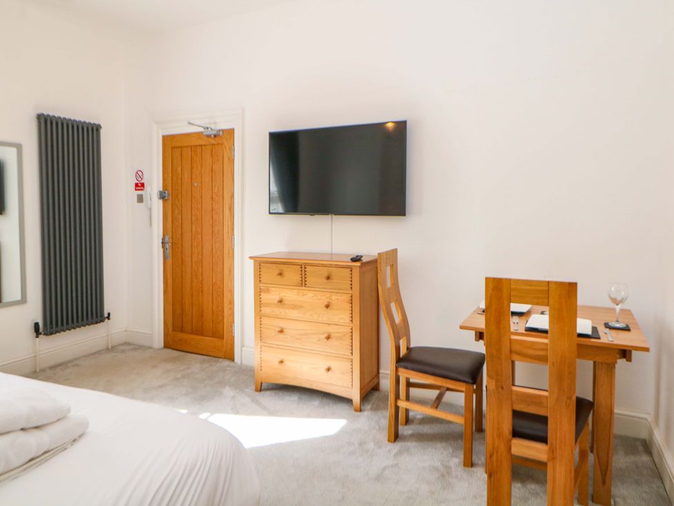 A bedroom with a bed and table at Lumsdale in Matlock Bath