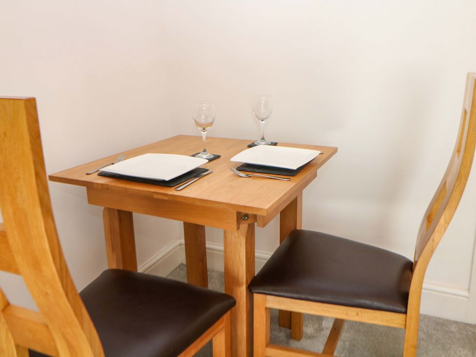 A dining table with two chairs set for dinner at Lumsdale in Matlock Bath