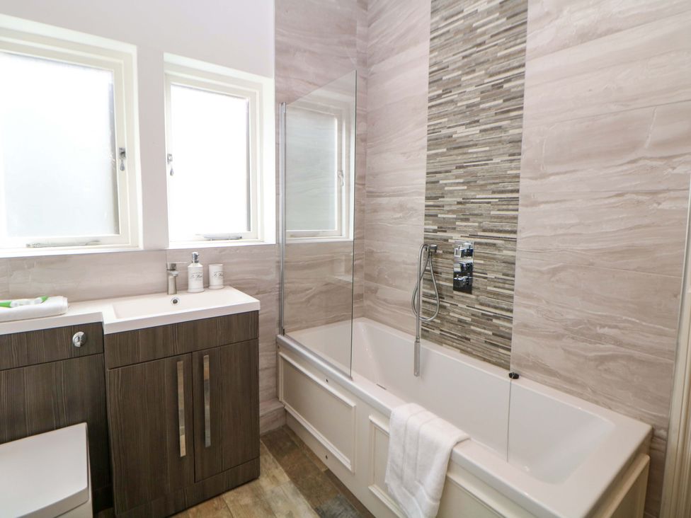 A bathroom with a bathtub and sink at Lumsdale in Matlock Bath
